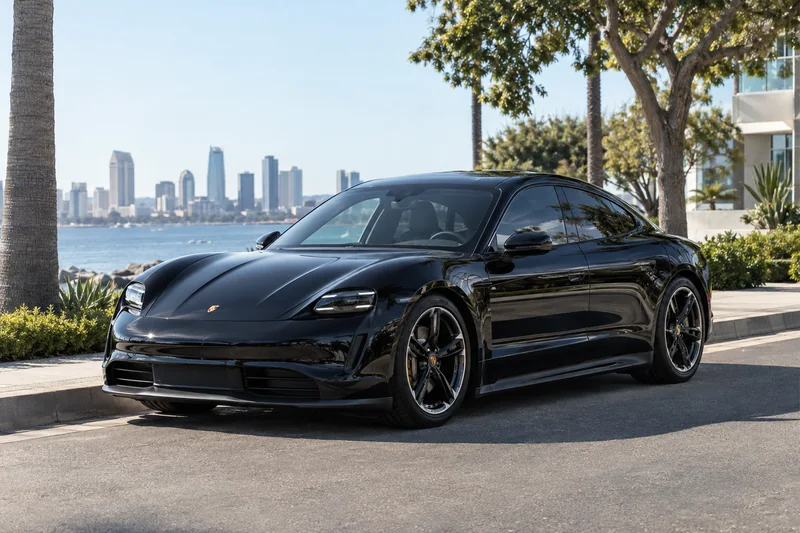 Black Porsche Taycan with ceramic window tint in the sun